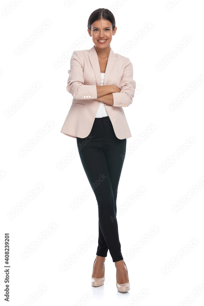 brunette businesswoman in pink jacket crossing arms and smiling brunette businesswoman in pink jacket crossing arms and smiling