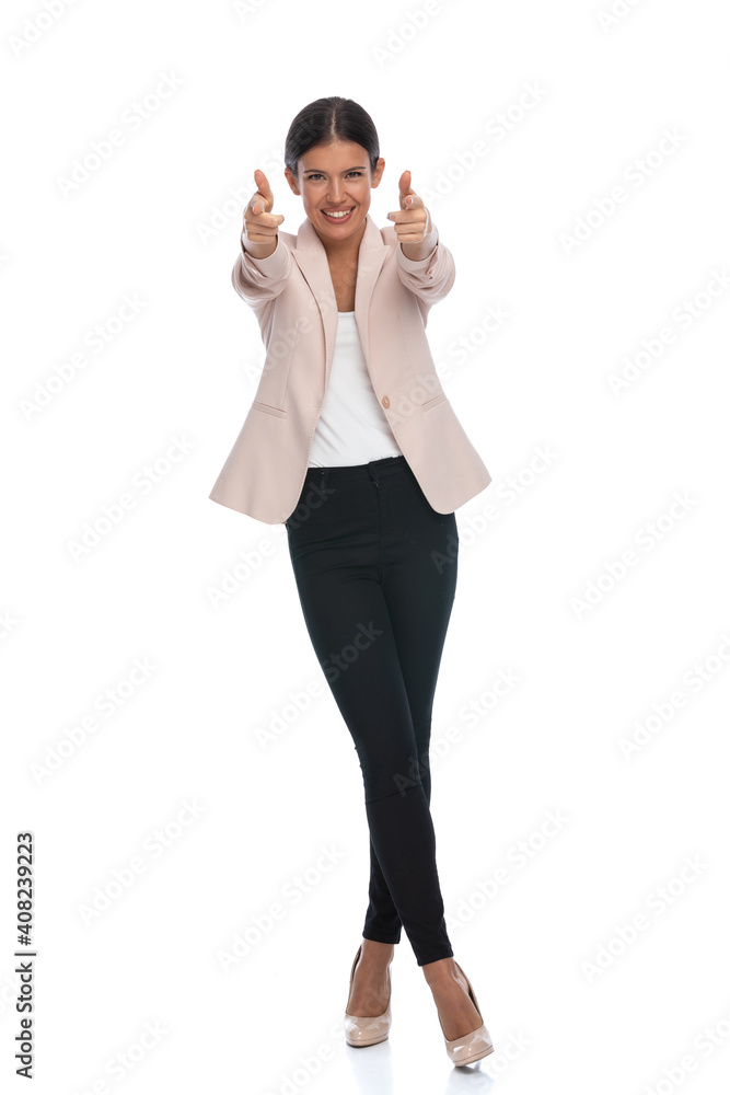happy smart casual girl smiling and pointing fingers happy smart casual girl smiling and pointing fingers