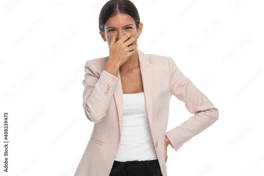 funny smart casual woman covering mouth with hand and laughing funny smart casual woman covering mouth with hand and laughing