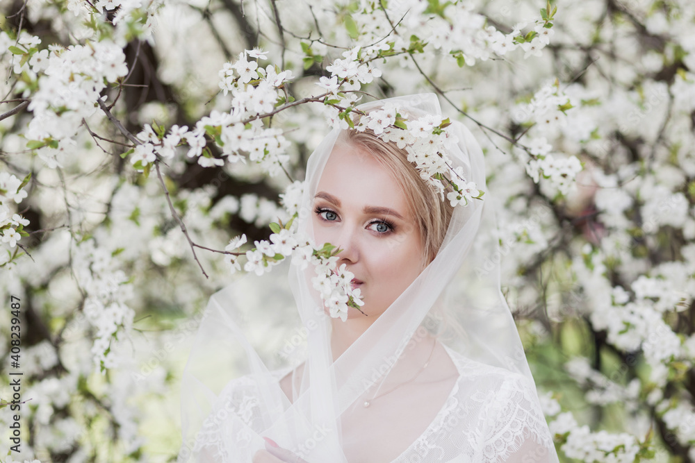 bride in wedding dress in blossom garden