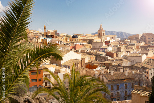 Panorama of the old town of Relleu on the Mediterranean coast in the province of Alicante, Spain, tiled roofs of the church dome and beautiful pealms