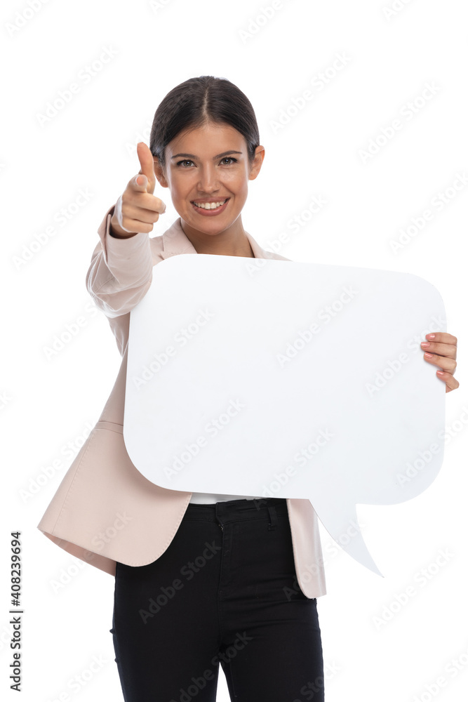 smiling young woman pointing fingers and presenting speech bubble smiling young woman pointing fingers and presenting speech bubble