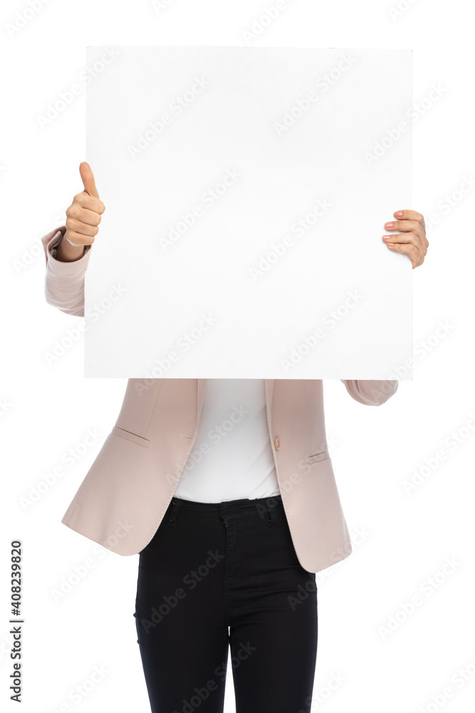 smart casual woman covering face with empty board smart casual woman covering face with empty board