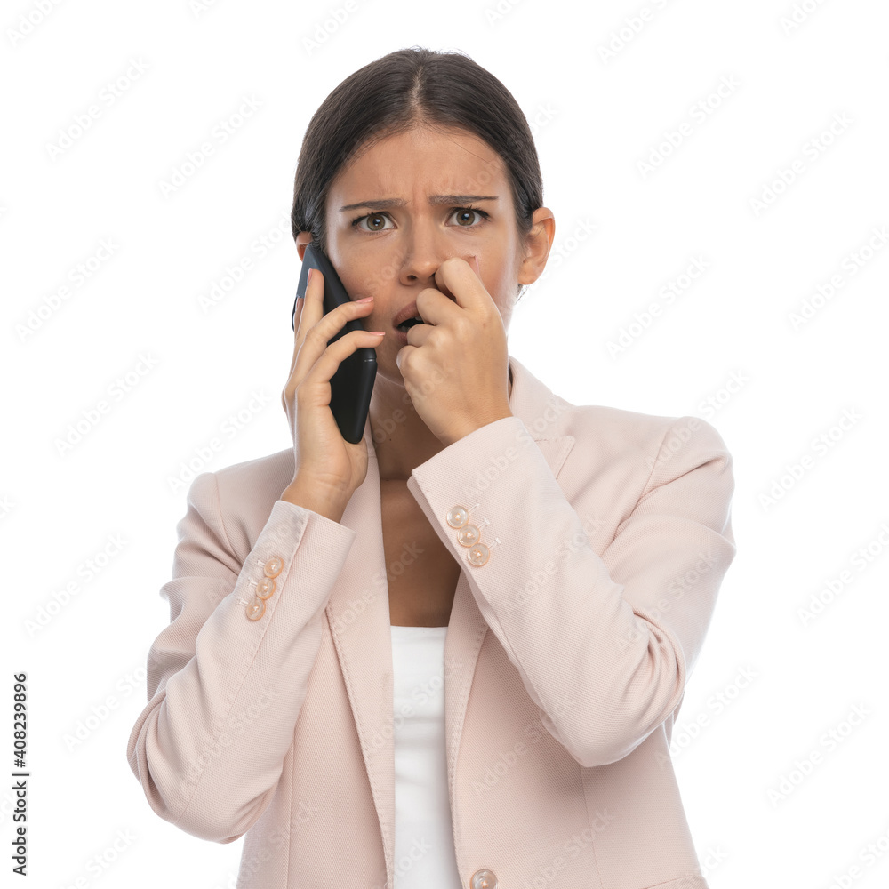 scared young woman in pink jacket talking on the phone scared young woman in pink jacket talking on the phone
