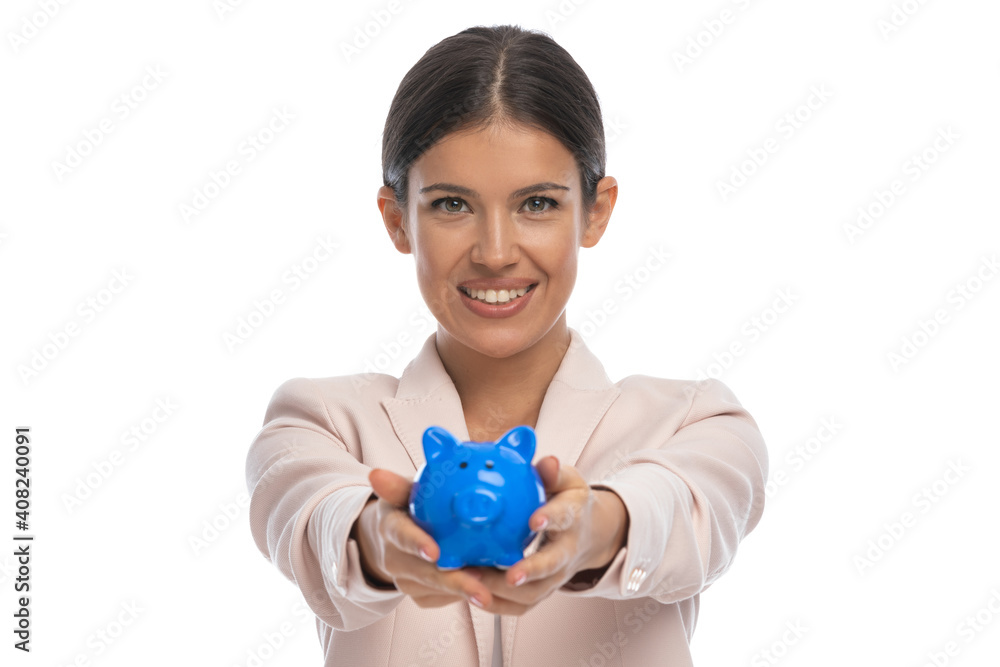 happy young businesswoman in pink jacket presenting piggy bank happy young businesswoman in pink jacket presenting piggy bank