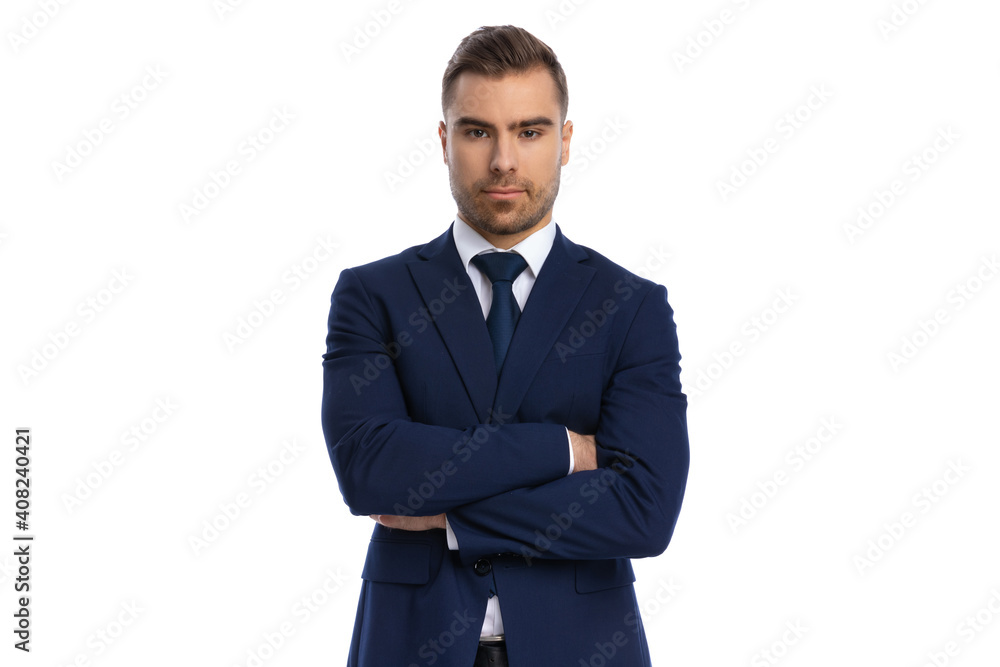 serious young man in navy blue suit folding arms and posing serious young man in navy blue suit folding arms and posing
