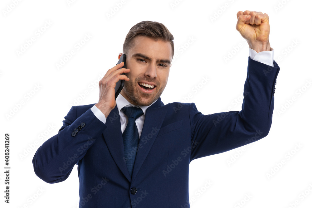 enthusiastic young model talking on the phone and celebrating enthusiastic young model talking on the phone and celebrating