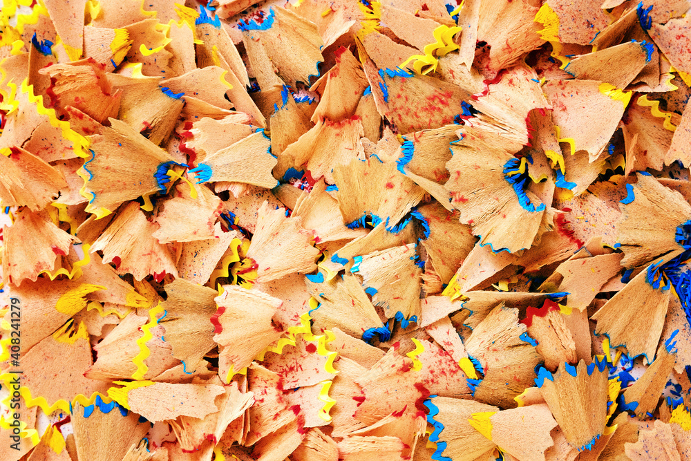 Sawdust from sharpening pencils fill the entire frame - Background image for text inscription - Shavings of colored pencils close-up - Concept of creativity and creation of art objects
