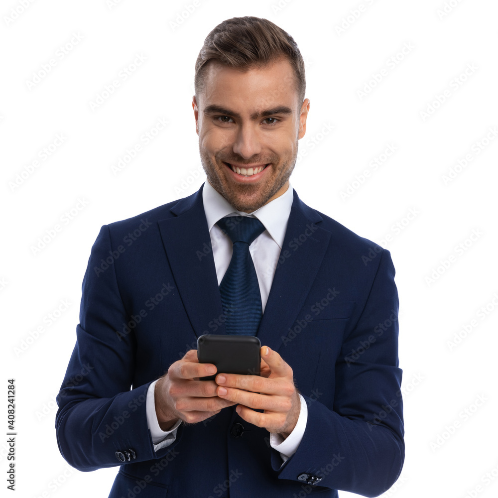 cheerful happy man in elegant suit texting messages and laughing cheerful happy man in elegant suit texting messages and laughing