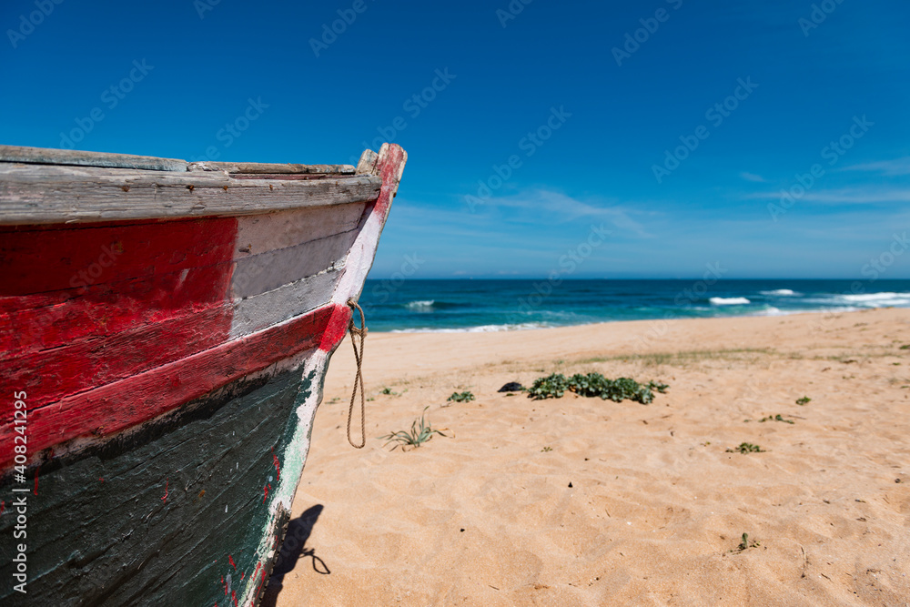 Detail of the bow of a colorful traditional fishing boat in a beach near the city of El Jadida in the Atlantic coast of Morocco. Detail of the bow of a colorful traditional fishing boat in a beach near the city of El Jadida in the Atlantic coast of Morocco.