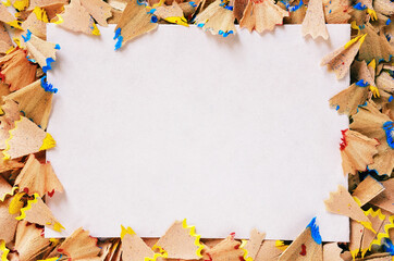 White sheet of paper and shavings of pencil around the perimeter - Baner of white color with paper for your inscription surrounded by scattered shavings from pencil - Paper with copy space for text
