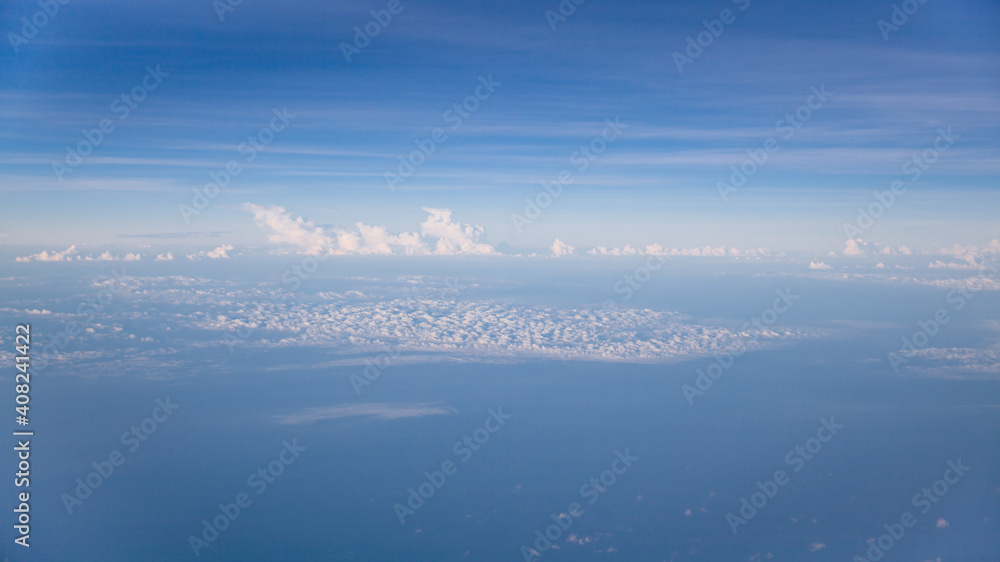 Fototapeta premium Aerial view of Blue sky and Cloud Top view from airplane window,Nature background. Sky and clouds.