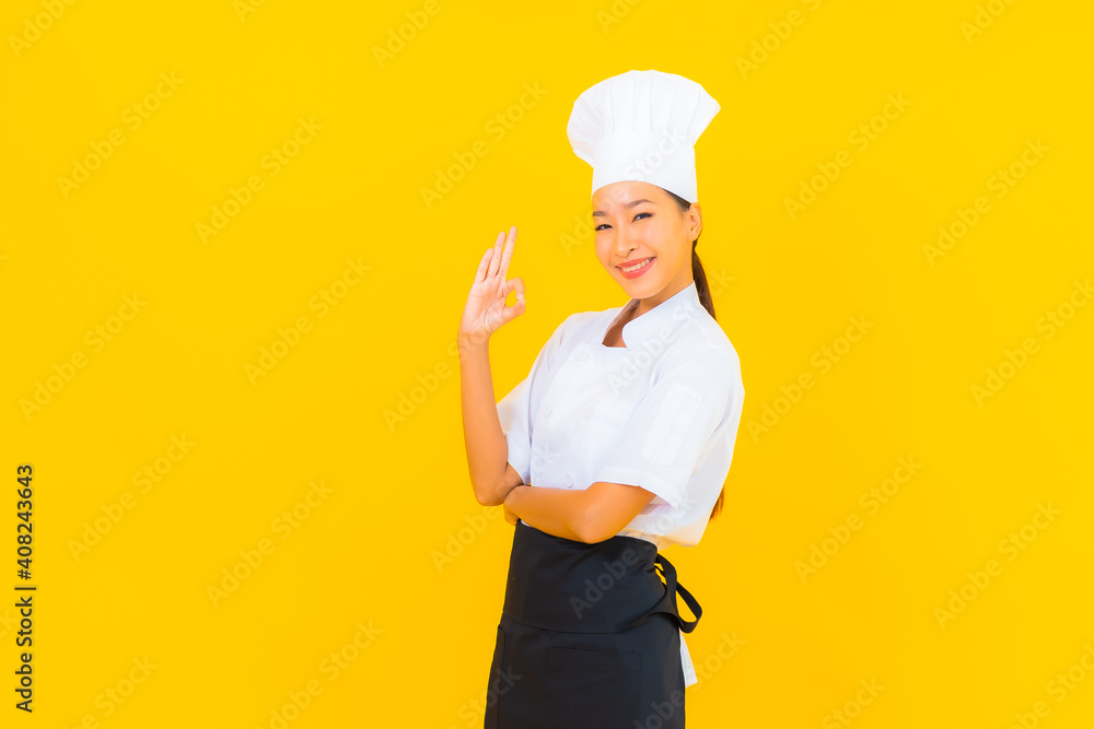 Portrait beautiful young asian woman in chef or cook uniform with hat