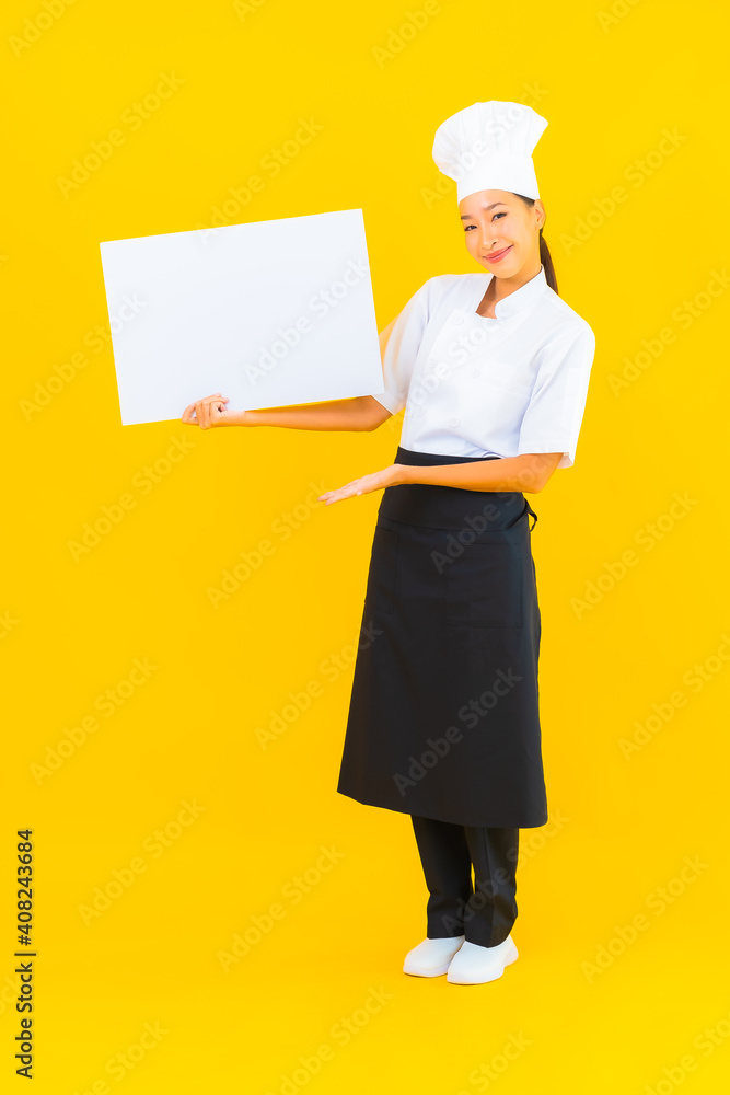 Portrait beautiful young asian chef woman with white empty billboard Portrait beautiful young asian chef woman with white empty billboard