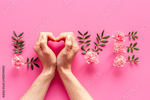 Word Love made of flowers and hands - Valentines Day background  top view