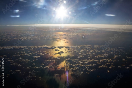 evocative image of clouds seen from an airplane with the sea in the background 