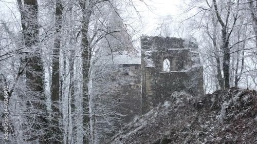Old ruins of medieval castle in snowfall