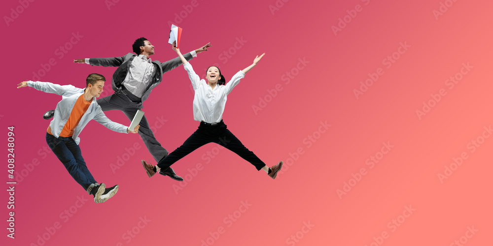 Happiness. Happy office workers jumping and dancing in casual clothes or suit isolated on gradient neon fluid background. Business, start-up, working open-space, motion, action concept. Creative Happiness. Happy office workers jumping and dancing in casual clothes or suit isolated on gradient neon fluid background. Business, start-up, working open-space, motion, action concept. Creative