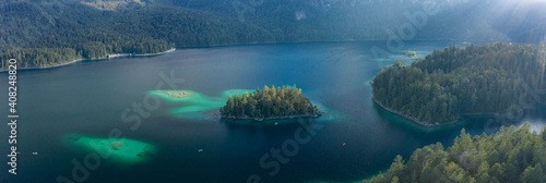 Panoramic aerial view of Eibsee lake island tree by Zugspitze before sunset in Germany