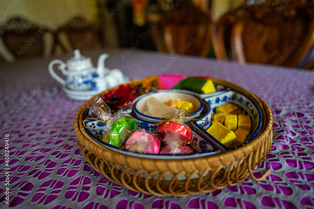 View of Vietnamese food for Tet holiday in spring, jam is traditional food and teapot set on lunar new year. Dried fruit and jam as tradition dessert - Mut Tet on wooden table. View of Vietnamese food for Tet holiday in spring, jam is traditional food and teapot set on lunar new year. Dried fruit and jam as tradition dessert - Mut Tet on wooden table.