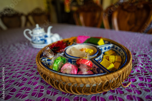 View of Vietnamese food for Tet holiday in spring, jam is traditional food and teapot set on lunar new year. Dried fruit and jam as tradition dessert - Mut Tet on wooden table.
