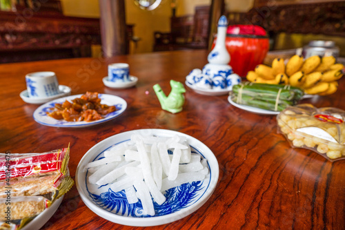 View of Vietnamese food for Tet holiday in spring, jam is traditional food and teapot set on lunar new year. Dried fruit and jam as tradition dessert - Mut Tet on wooden table. photo