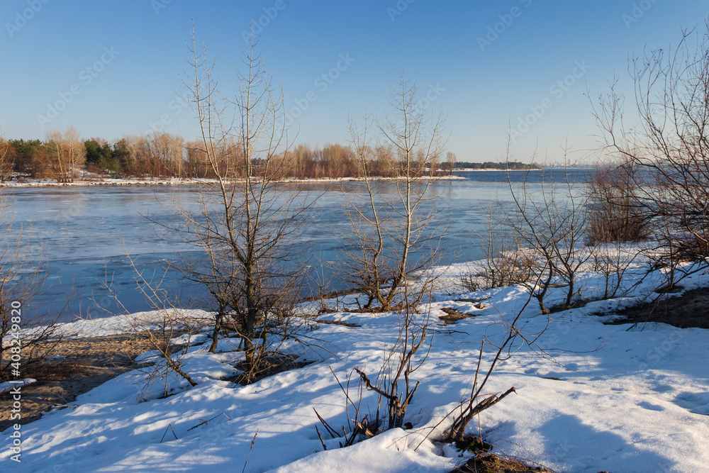 Plain river partially covered with ice in early spring Plain river partially covered with ice in early spring