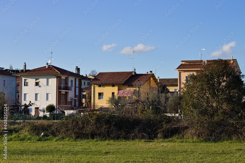 Houses in a suburb behind a lawn (Pesaro, Italy, Europe)