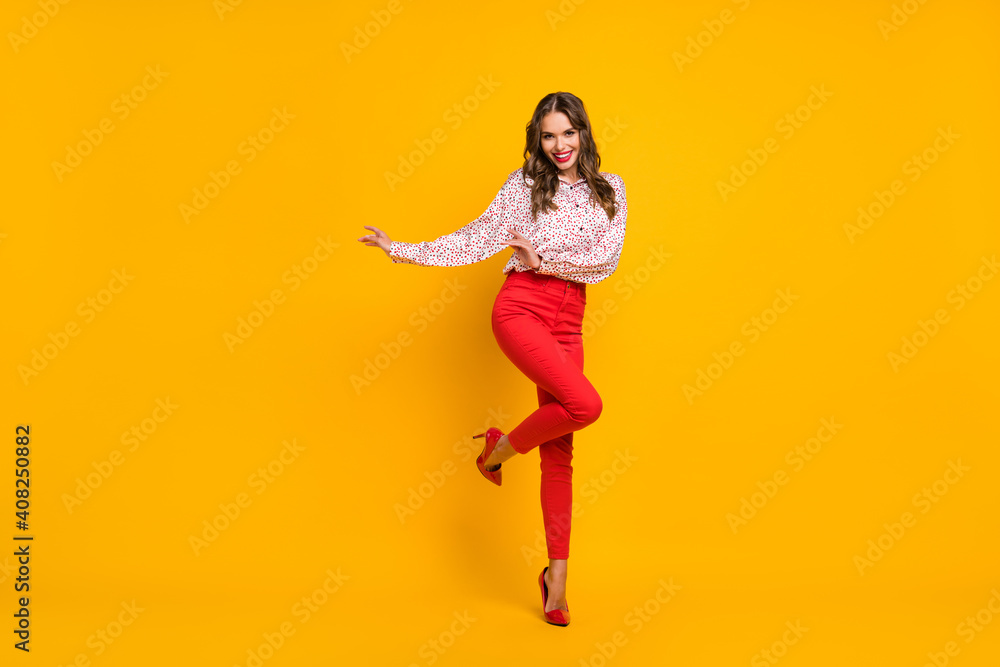 Full length portrait of charming lady partying raise knee wear red stilettos isolated on yellow color background