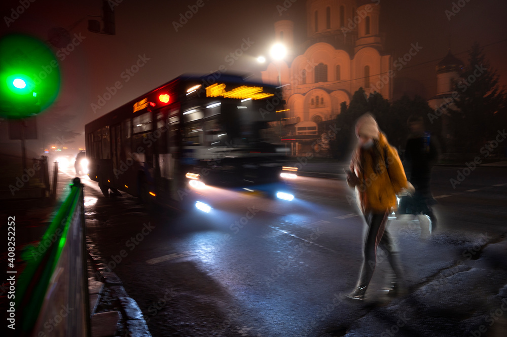 Busy city street people on zebra crossing at night. Dangerous situation
