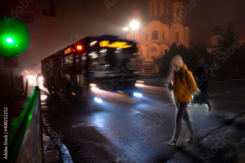 Busy city street people on zebra crossing at night. Dangerous situation