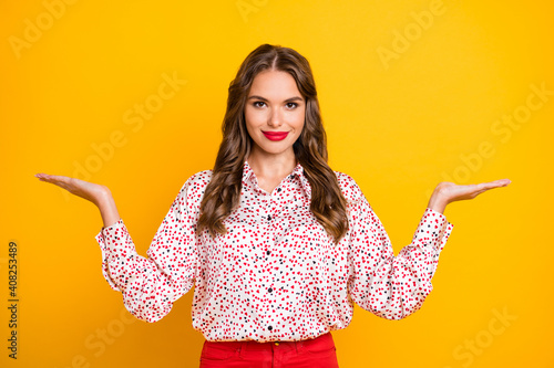 Portrait of attractive person arms palms demonstrate products proposition isolated on yellow color background