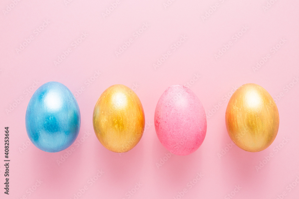 Multi-colored Easter eggs on a pink isolated background. Easter is a bright holiday. Multi-colored Easter eggs on a pink isolated background. Easter is a bright holiday.