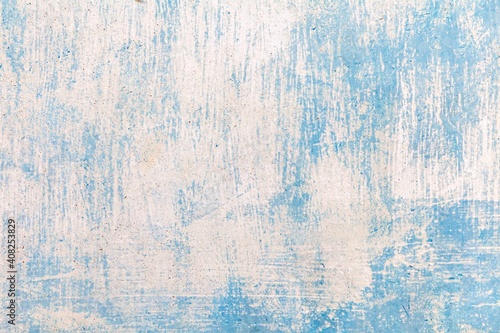 Old plaster wall painted in pastel blue vintage texture and seamless background