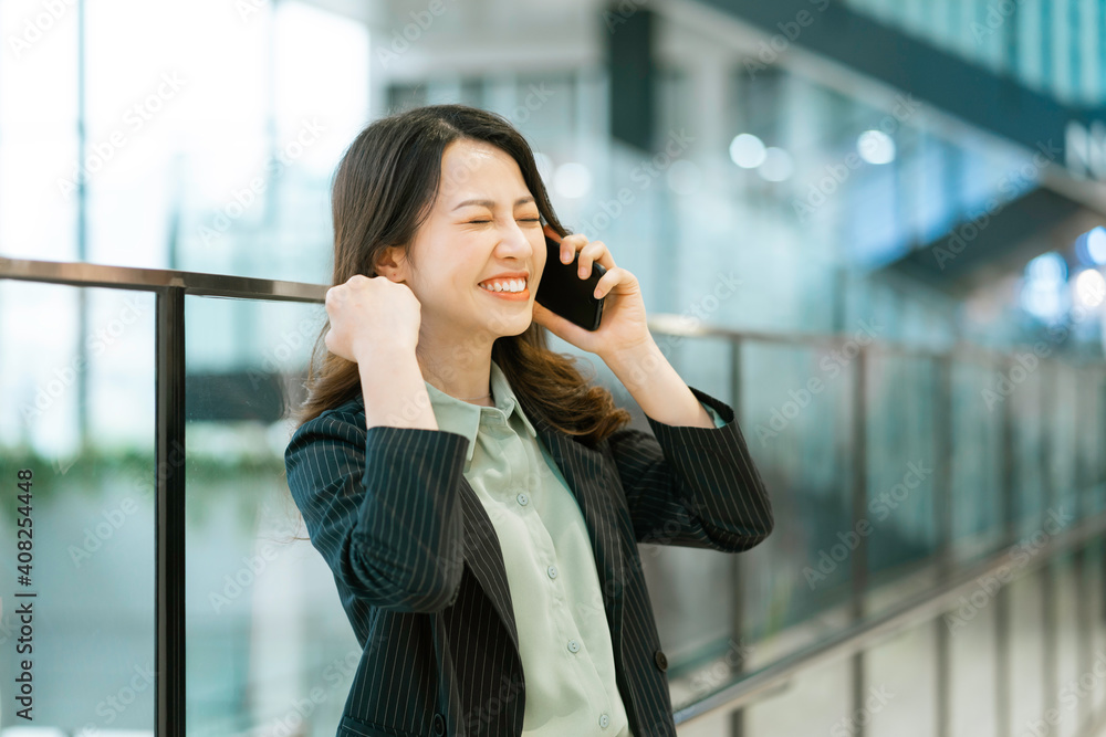 Portrait of a young Asian female director holding a phone Portrait of a young Asian female director holding a phone