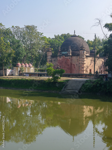 Scenic ancient Atiya or Atia mosque view from the back with reflection in pond, Tangail district, Bangladesh