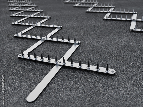 Fotografie Road spike or tire trap on asphalt background. 3D illustration