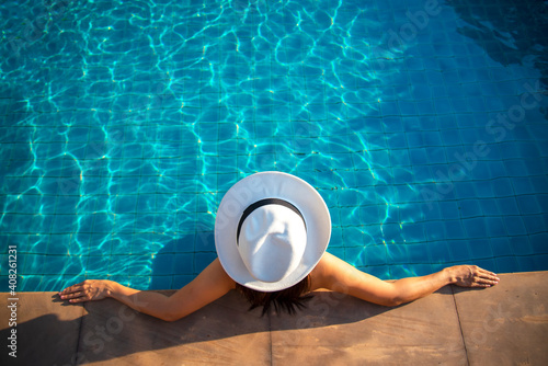 Women relaxing near luxury swimming pool