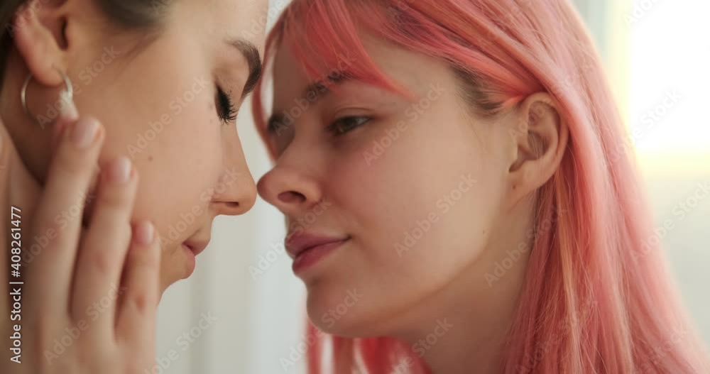 Loving female gay couple touching forehead with tenderness Loving female gay couple touching forehead with tenderness