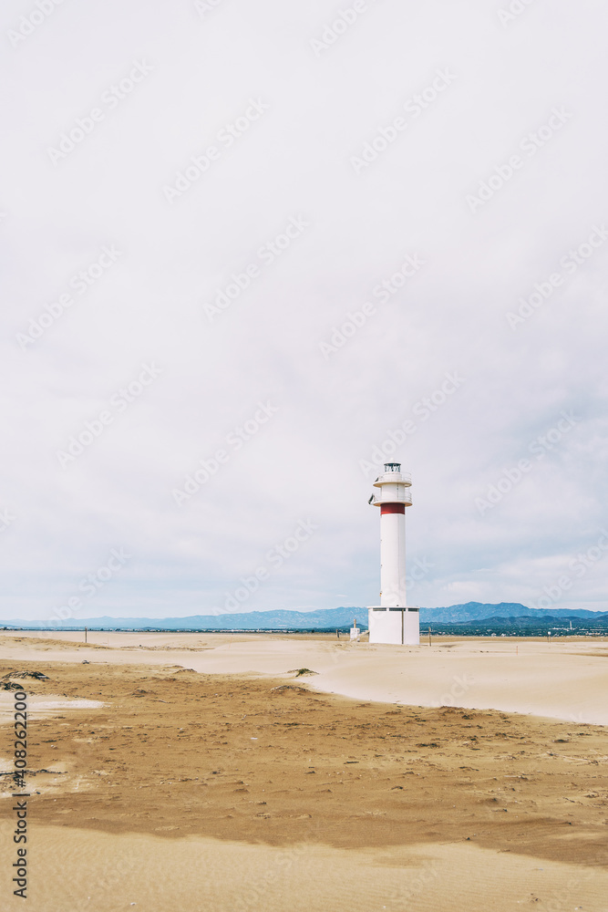 lighthouse on the lonely beach of delta del ebro, tarragona, spain.