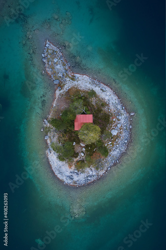 Fototapeta Naklejka Na Ścianę i Meble -  tiny red house on a island