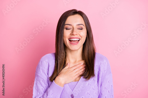 Portrait of optimistic girl laugh hand chest wear lilac sweater isolated on pink color background