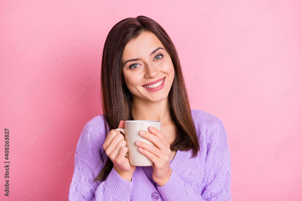 Portrait of optimistic girl hold cup wear lilac sweater isolated on pink color background Portrait of optimistic girl hold cup wear lilac sweater isolated on pink color background