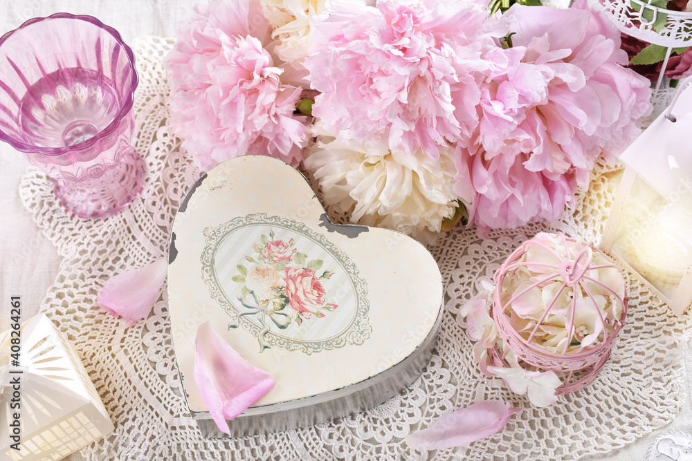 shabby chic style love arrangement with pink peonies and old heart shaped box