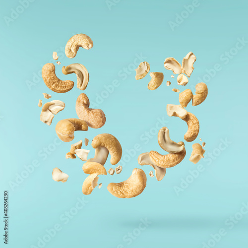 Fresh tasty Cashew nuts falling in the air photo