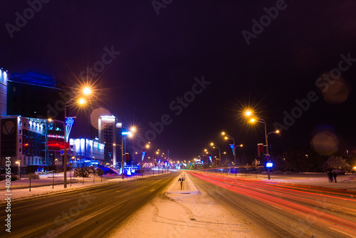 Winter night road in city, snow background