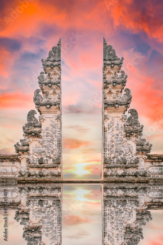 Stunning view of the Gate of Heaven with its reflection in the water during a beautiful sunset. Pura Lempuyang it's a must-visit place for tourists who want to strike a pose in Bali, Indonesia.