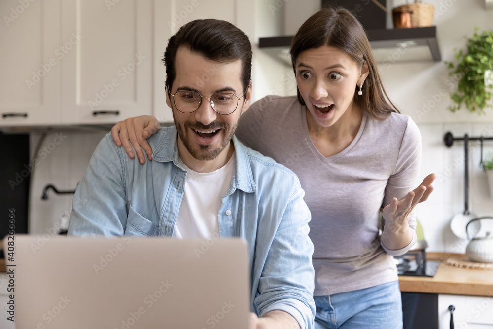 Great thing Excited young husband and wife feeling euphoria triumph reading email from bank getting loan approval. Astonished couple winning big money reward in lottery amazed with unexpected luck Great thing Excited young husband and wife feeling euphoria triumph reading email from bank getting loan approval. Astonished couple winning big money reward in lottery amazed with unexpected luck
