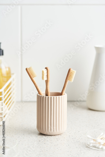 Bamboo toothbrushes in bathroom in morning