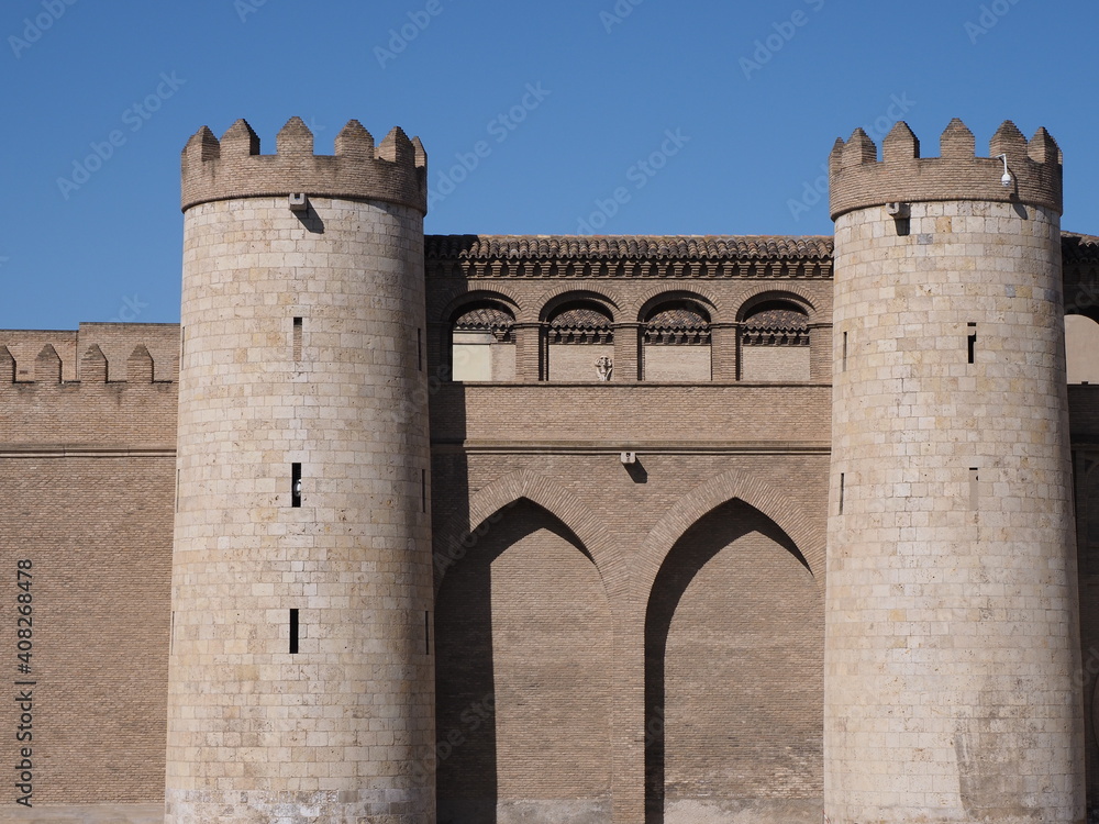 Walls with towers of palace in european Saragossa city at Aragon district in Spain, clear blue sky in 2019 warm sunny summer day on September.